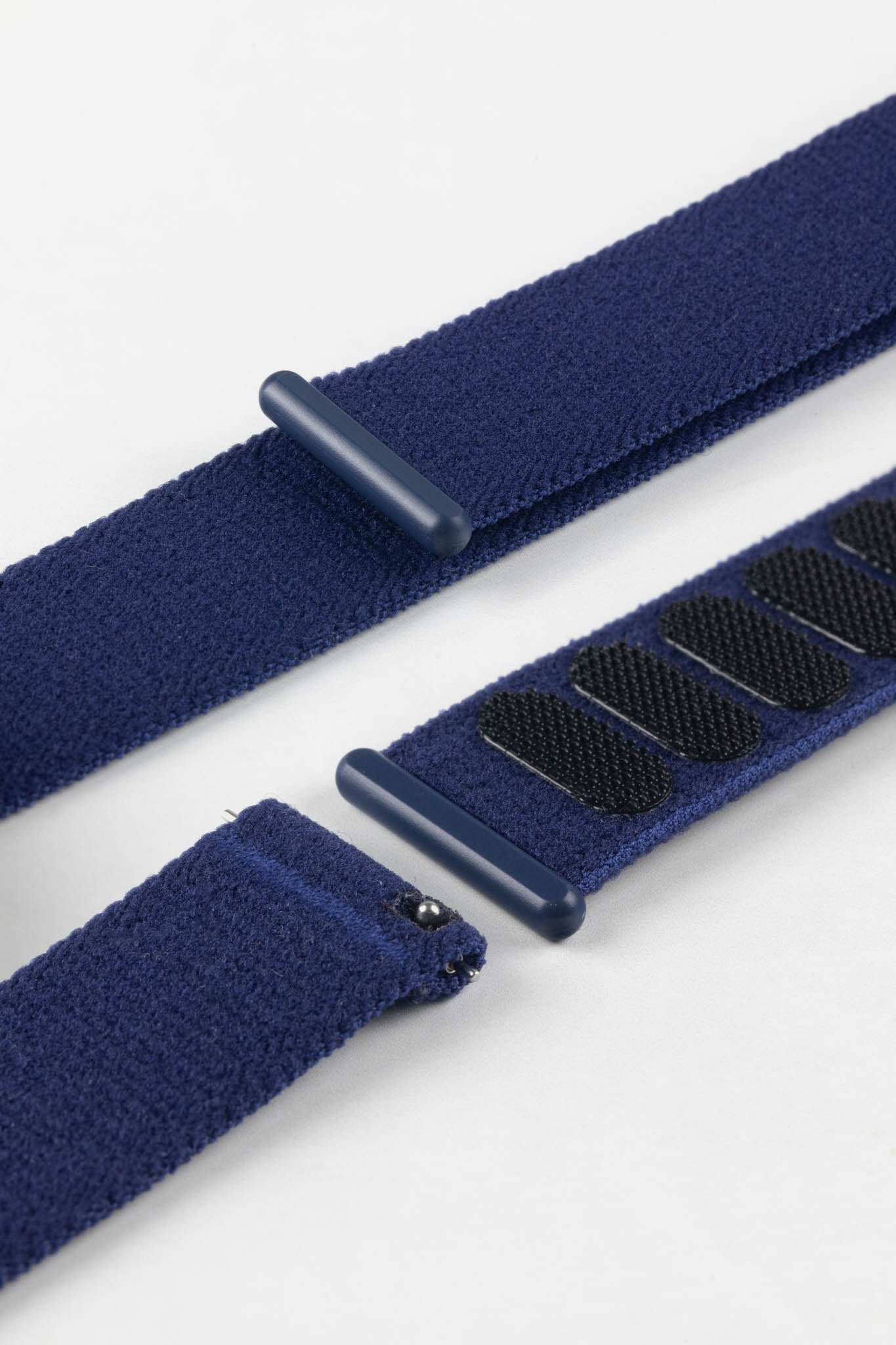 Detail showing the quick-release spring bar and dark blue loop of the durable HIRSCH Vocem Blue textile strap.
