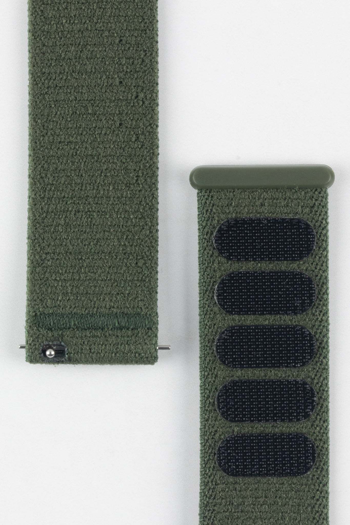 Close-up of HIRSCH Vocem Green textile strap showing its textured material and black hook-and-loop patches.