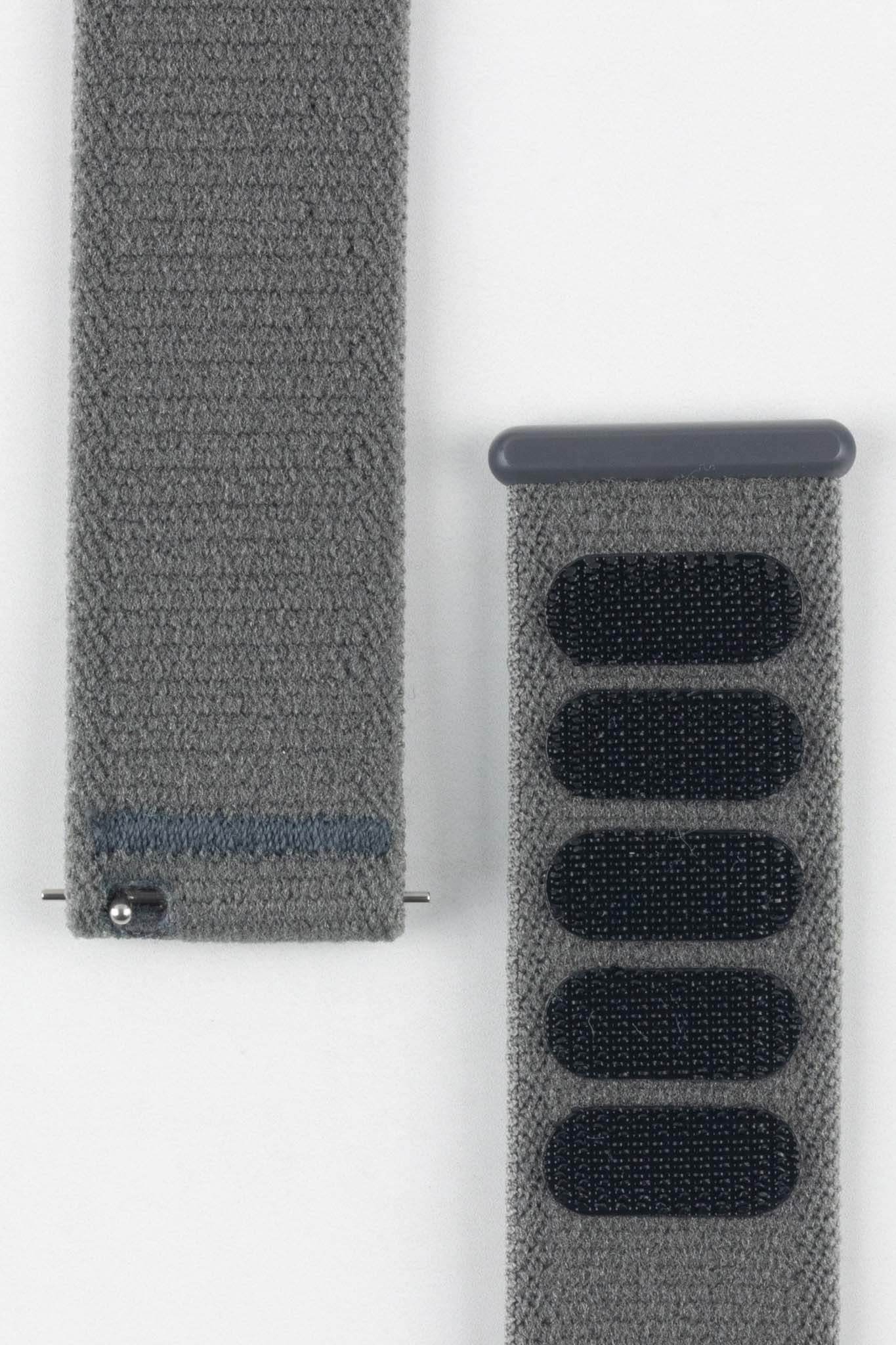 Close-up of HIRSCH Vocem Grey textile watch strap showing texture and dark closure fastener patches.