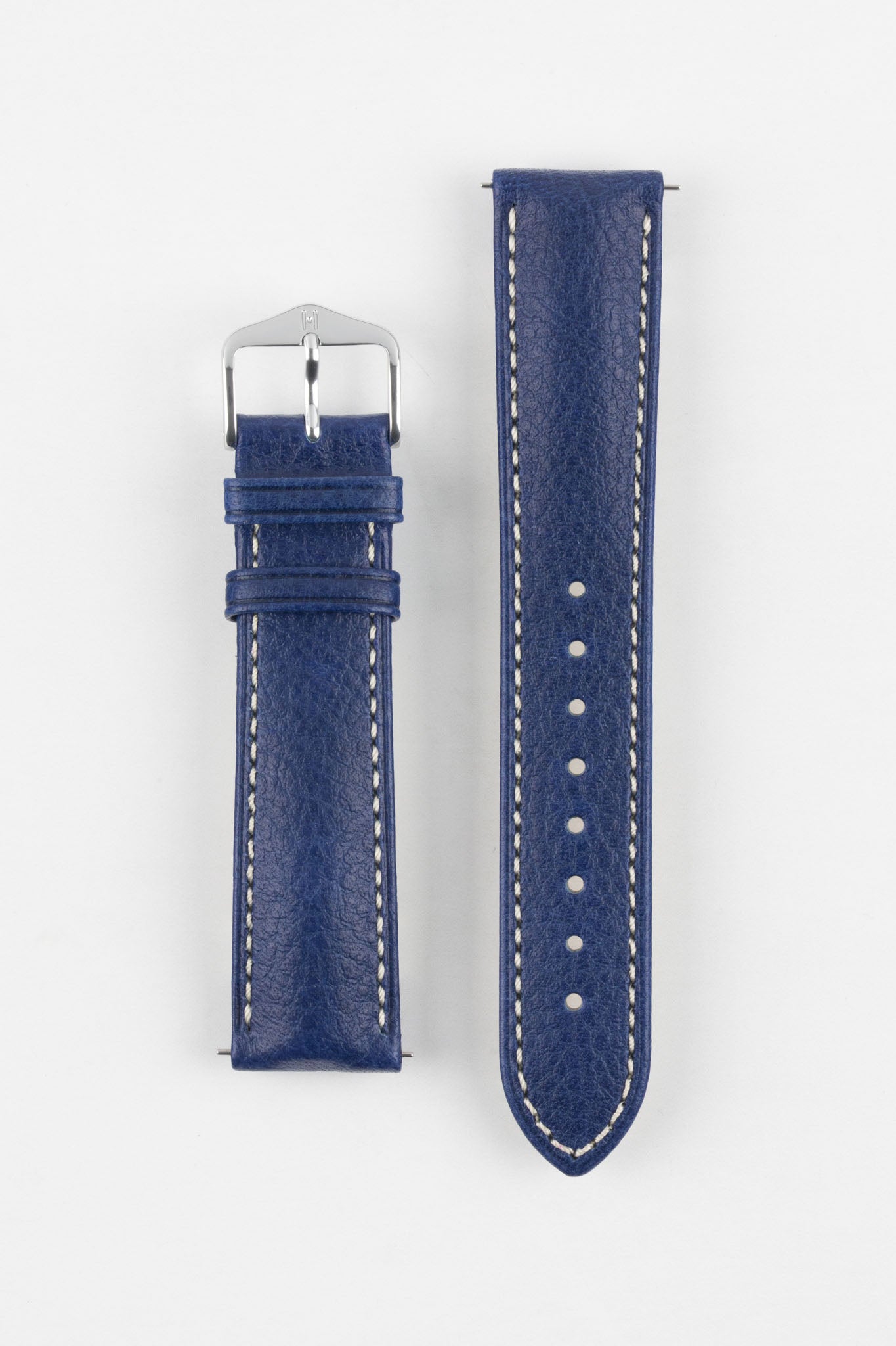 Top-down flat lay of a two-piece blue textured leather watch strap with white stitching and a silver pin buckle on a white background.