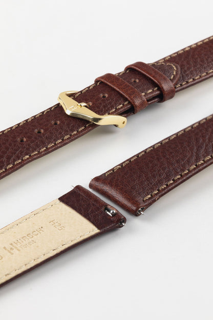 HIRSCH Forest brown quick-release watch strap with a polished gold buckle, showcasing the grained leather finish.