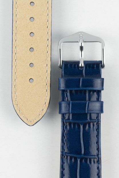 Close-up of the Louisianalook Blue embossed watch strap showing the tan lining and polished silver buckle.
