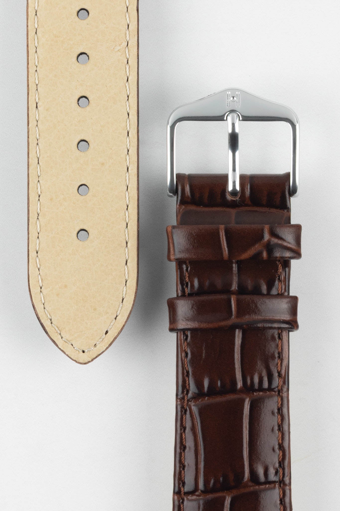 Close-up of the Louisianalook Brown strap showing the tan lining and the silver buckle with logo detail.
