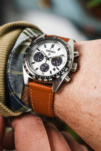 Gold Brown hirsch bologna leather watch strap fitted to seiko prospex speedtimer black and white panda chronograph on wrist